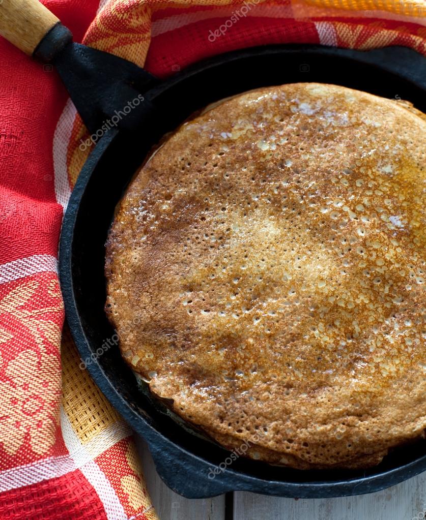 Pancakes in castiron pan Stock Photo by ©Yulia_Kotina 19701077