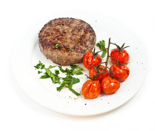 Dana biftek ve pişmiş domates — Stok fotoğraf