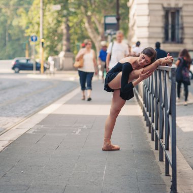 Young beautiful ballerina dancing along the street in Rome, Ital
