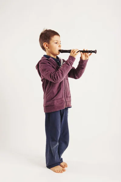 Child playing flute. — Stock Photo, Image