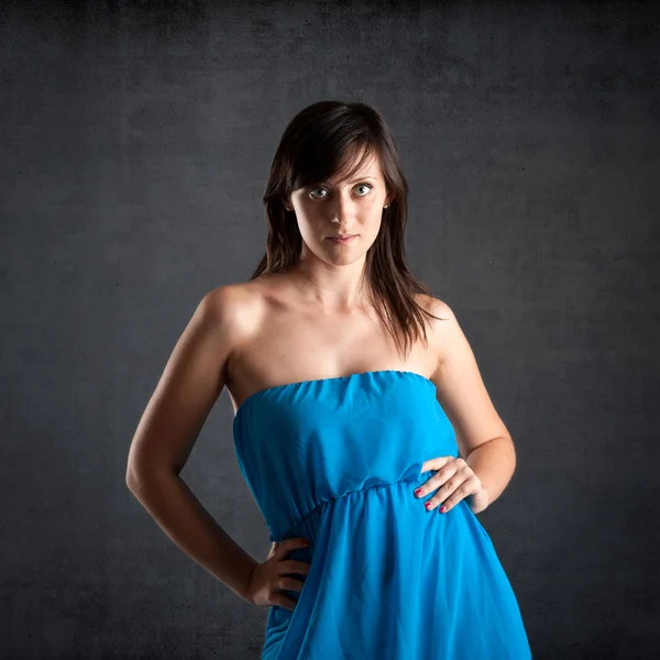 Beautiful woman close up portrait against dark grunge background — Stock Photo, Image