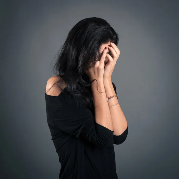 Woman close up portrait on dark background. Desperate expression — Stock Photo, Image