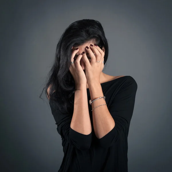 Woman close up portrait on dark background. Desperate expression — Stock Photo, Image