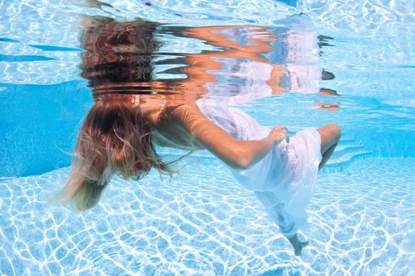 Podvodní žena portrét móda bílých šatech v bazénu — Stock fotografie