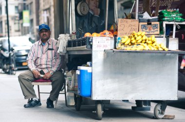 NEW YORK CITY - JUN 24: Food seller in NYC on June 24, 2012. New clipart