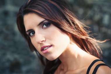 yoğun güzel kız portre. taş duvar arka plan.