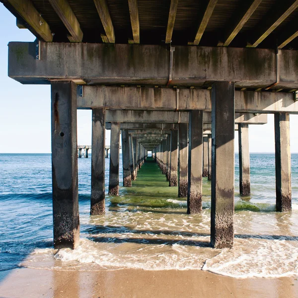 View below the pier. Beach at Coney Island, New York City. — Stock Photo, Image