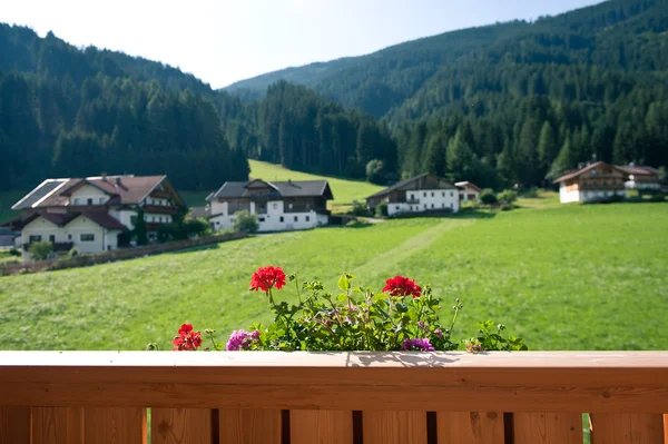 Mountain house terrace with flowers. Dolomites, Italy. — Stock Photo, Image