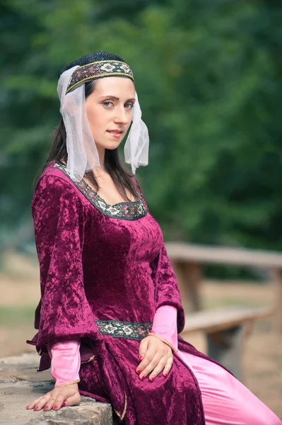 Beautiful girl wearing a burgundy medieval dress — Stock Photo, Image