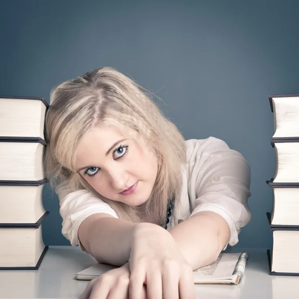 Young girl studying against dark background — Stock Photo, Image