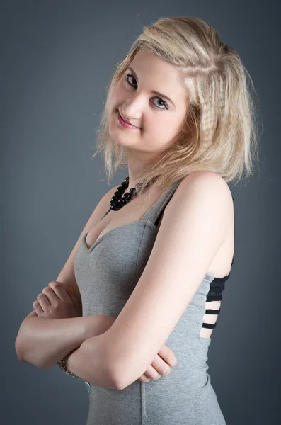 Portrait of blonde teenager girl on dark background — Stock Photo, Image