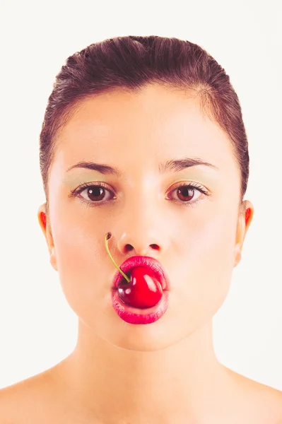 Close up portrait of beautiful young woman with cherry against white background — Stock Photo, Image