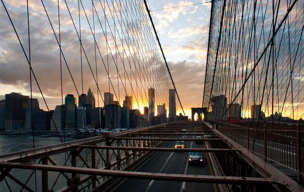 Panoramic shot of Manhattan skyline from the Brooklyn bridge at evening
