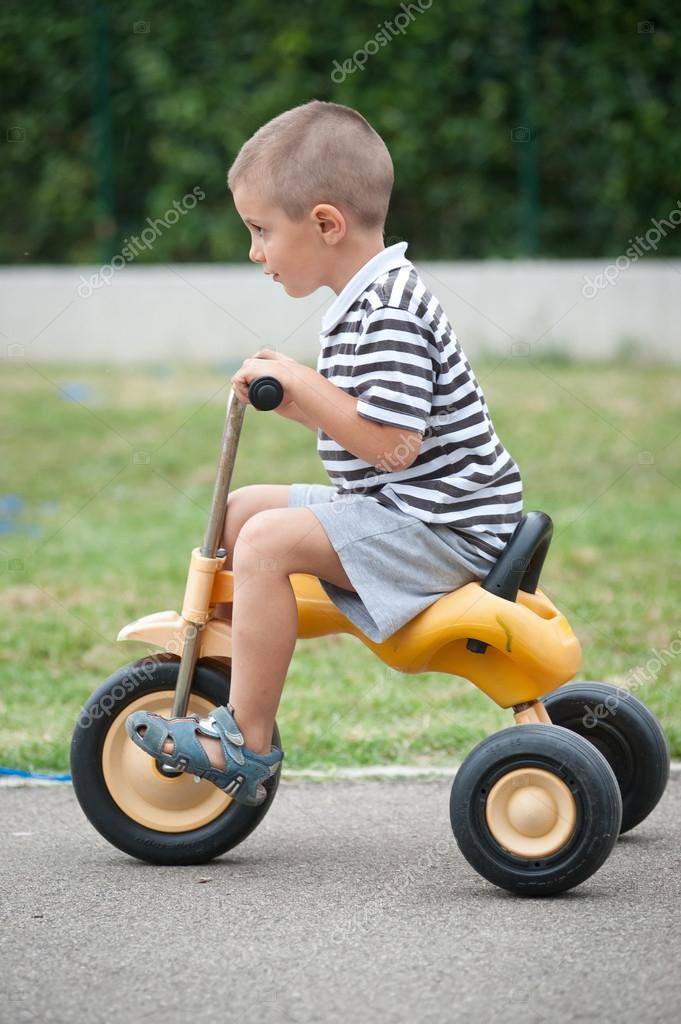 kid on tricycle