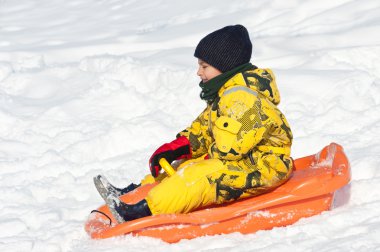 Çocuk karda Bob 'la kayıyor.
