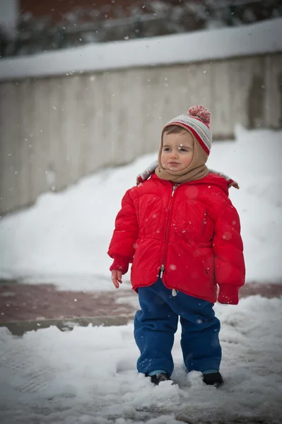 Portrait of baby girl with pink ski suit in the snow — Stock Photo, Image