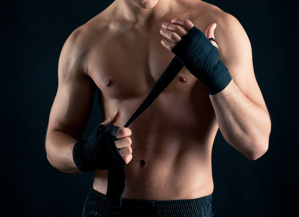 Sportsman boxer intense studio portrait against black background