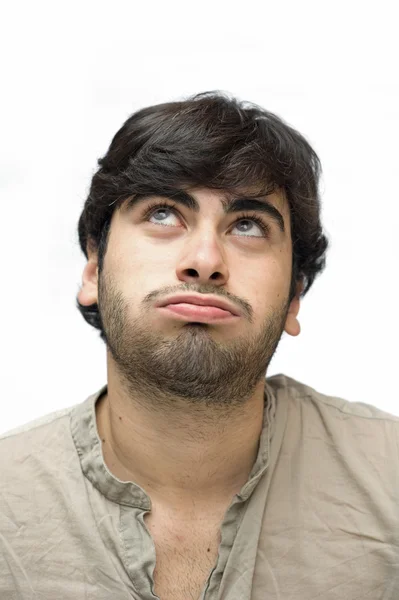 Casual man looking up over white background with unsatisfied expression — Stock Photo, Image