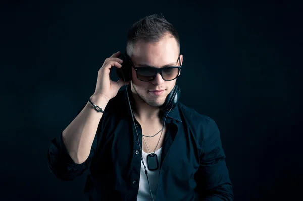 Portrait of man with ear-phones on black background — Stock Photo, Image