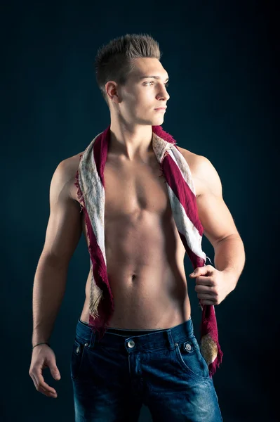 Portrait of confident young man shirtless against black background — Stock Photo, Image