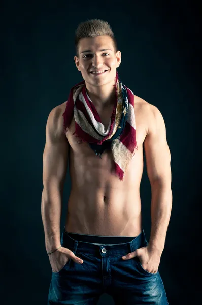 Portrait of confident young man shirtless against black background — Stock Photo, Image