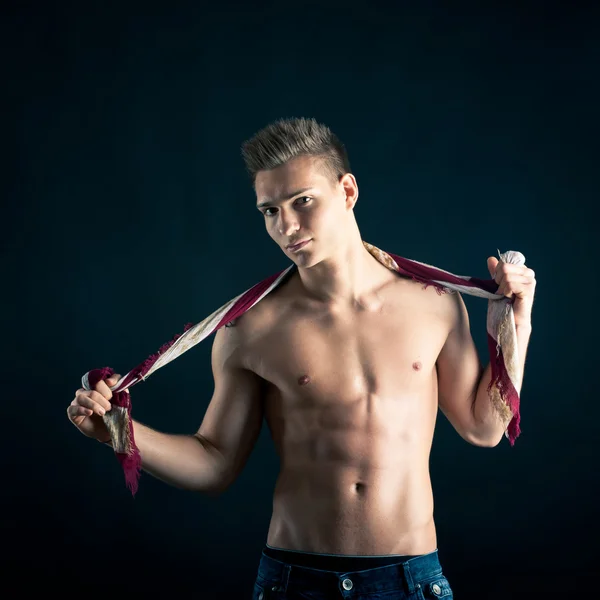 Portrait of confident young man shirtless against black background — Stock Photo, Image