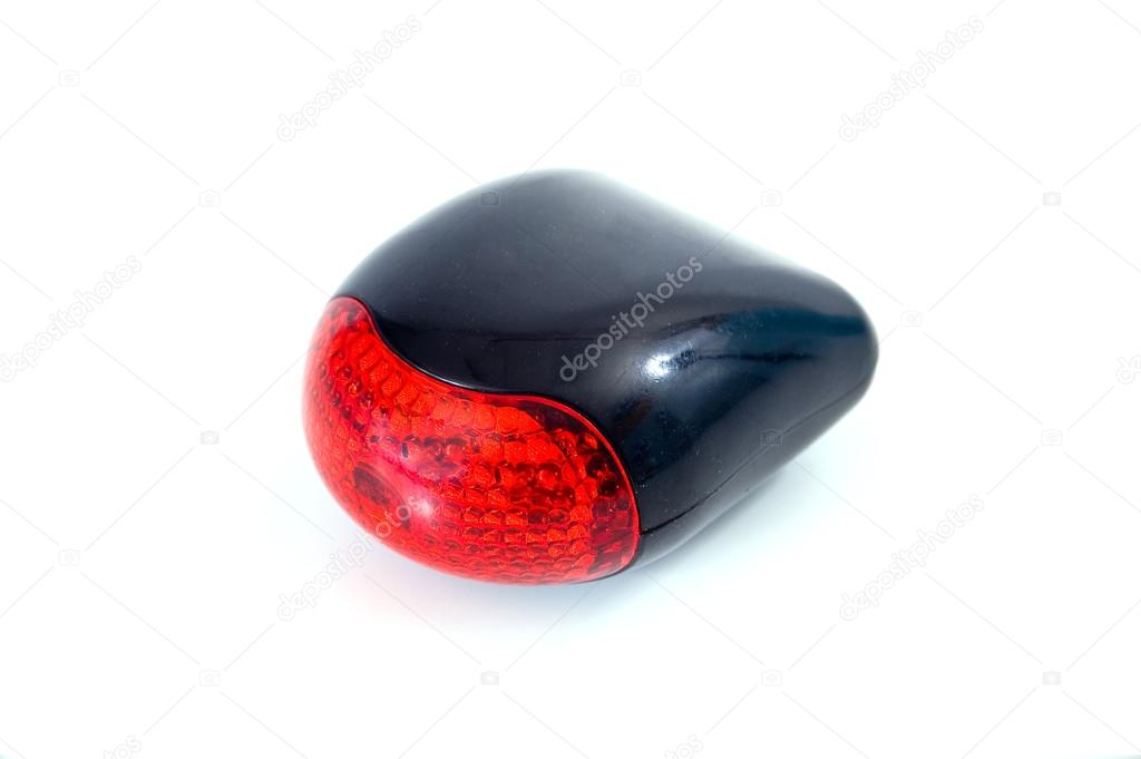 Red bicycle rear lamp on white background