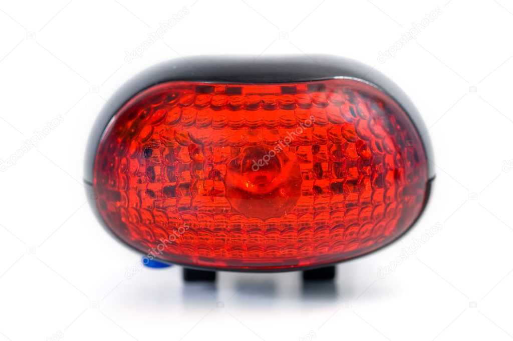 Red bicycle rear lamp on white background. Front view
