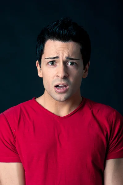 Worried man on dark background — Stock Photo, Image