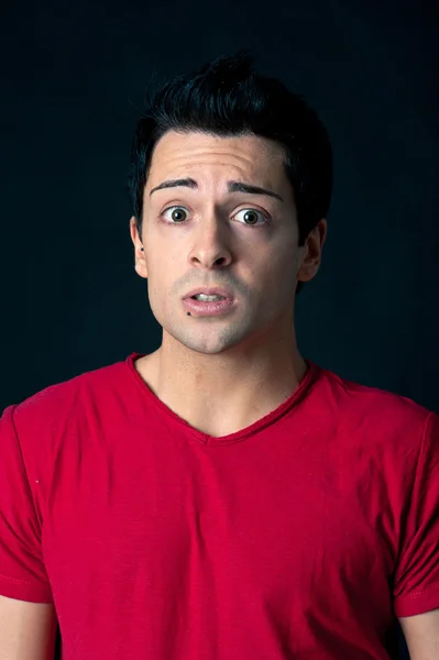 Surprised man on dark background — Stock Photo, Image