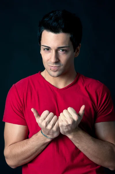 Man portrait with satisfied expression on dark background — Stock Photo, Image