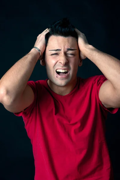 Man portrait with frustrated expression on dark background — Zdjęcie stockowe