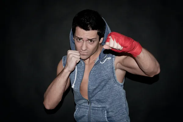 Portrait of young boxer on dark background — Stock Photo, Image