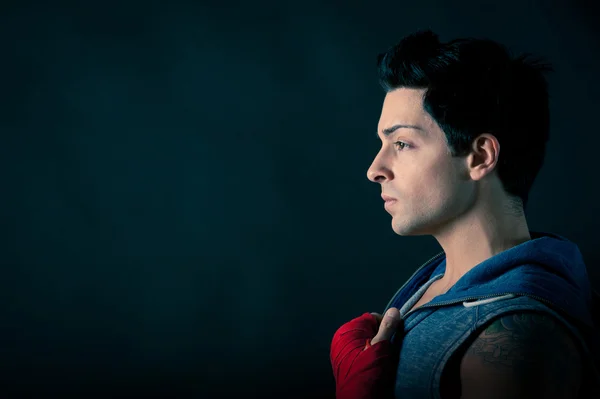 Profile of confident man with copy space against dark background