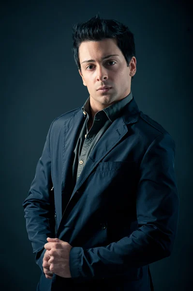 Portrait of handsome, confident man against dark background — Stock Photo, Image