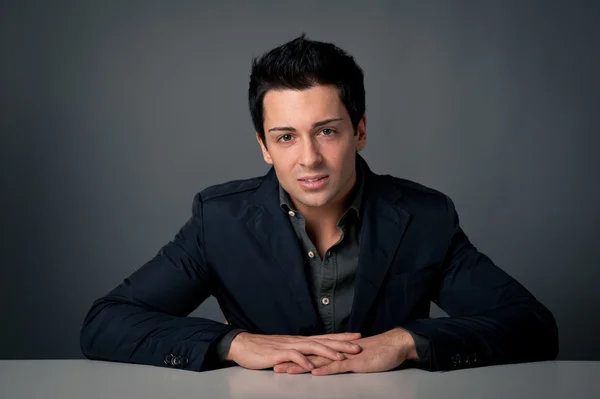 Portrait of handsome, confident man against dark background — Stock Photo, Image