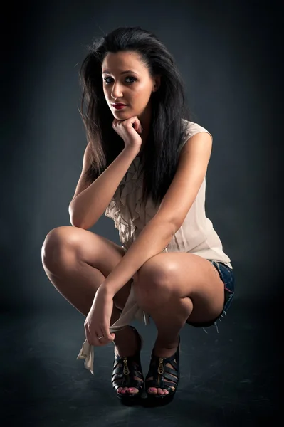 Beautiful woman portrait against dark background — Stock Photo, Image