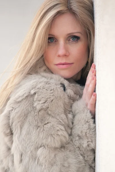 Close up portrait of young blond attractive woman with fur — Stock Photo, Image