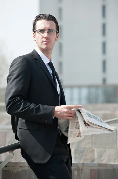 Young businessman with newspaper — Stock Photo, Image