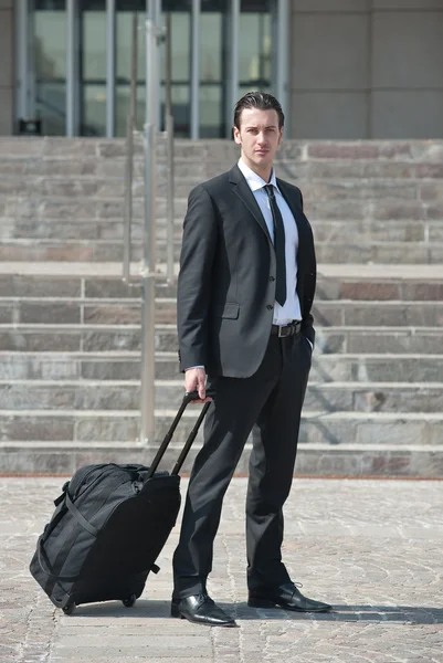 Young businessman with suitcase — Stock Photo, Image