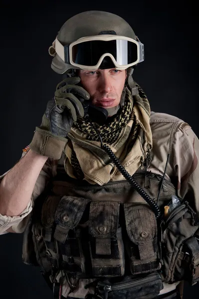 Soldier talking at the radio against black background — Stock Photo, Image
