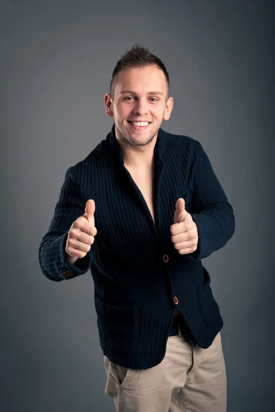 Happy casual man thumbs up over grey background — Stock Photo, Image