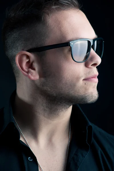 Young boy with sunglasses against black background — Stock Photo, Image