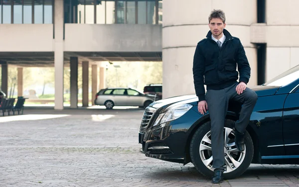 Joven retrato de hombre elegante con coche de lujo — Foto de Stock