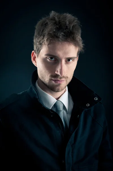 Portrait of handsome, confident man against dark background — Stock Photo, Image