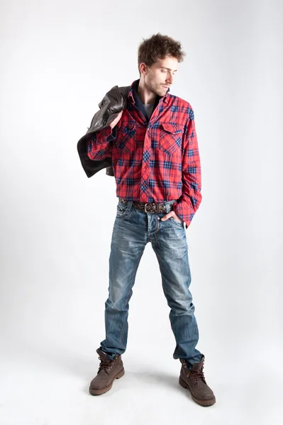 Portret van een jonge man met plaid shirt en lederen jas — Stockfoto