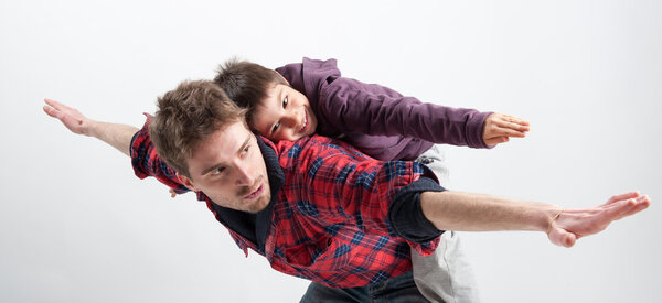 Young father and son playing together portrait. Studio shot