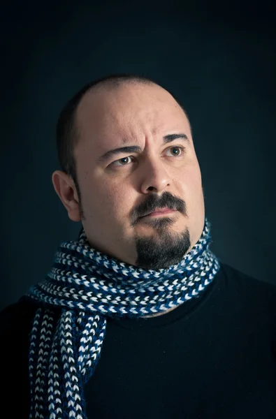 Man portrait with suspicious expression on dark background — Stock Photo, Image