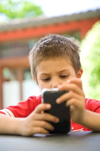 Small boy with cell phone — Stock Photo, Image