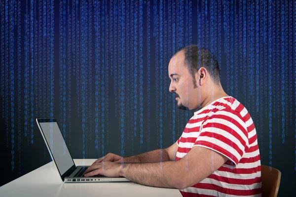 Portrait of young man working with laptop against digital background — Stock Photo, Image